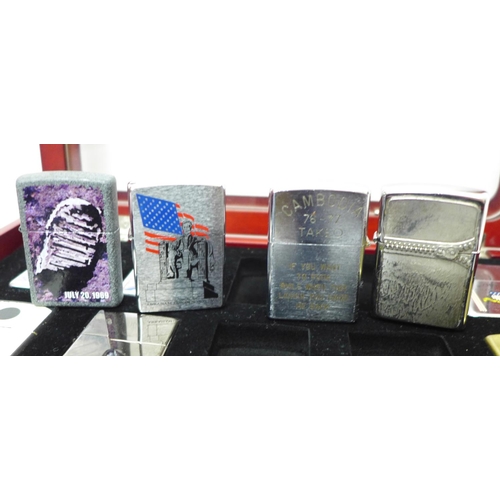 733 - Two cased sets of Zippo lighters, eight brass and twenty mixed, all bearing mottos or motifs