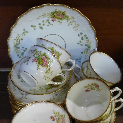 749 - An early 20th Century floral decorated tea service, 12 cups (two a/f), 11 saucers, 12 side plates, (... 