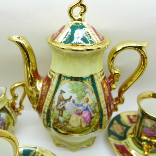 751 - A porcelain six setting coffee service with gilt decoration and classical scenes, marked Bavaria and... 