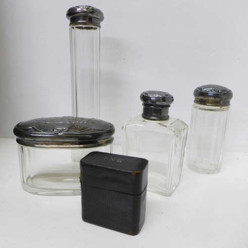 772 - A travel vanity case with four silver topped jars and two travel inkwells