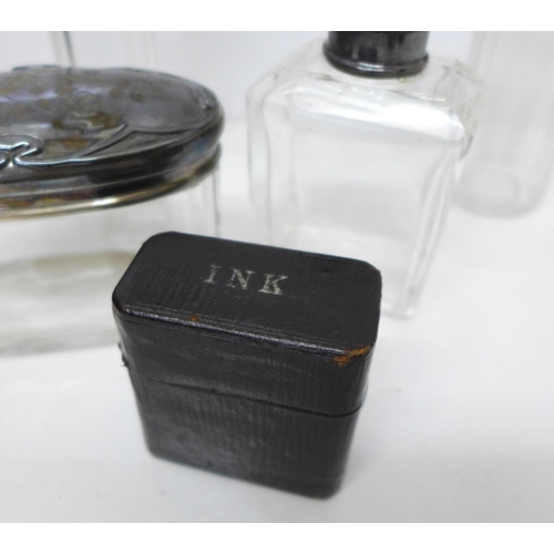 772 - A travel vanity case with four silver topped jars and two travel inkwells