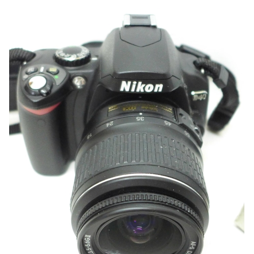 791 - A Nikon D40 camera with Nikon 18-55mm lens, a Nikon battery charger, battery and remote