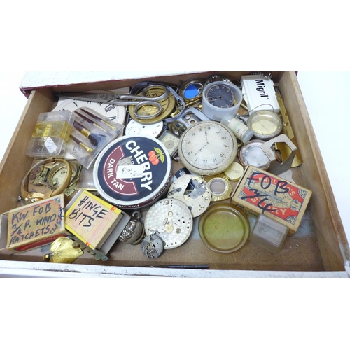 794 - A wood cabinet of mixed watch parts and watch materials