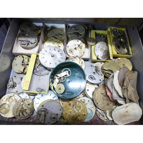 874 - A metal cabinet of watch movements in parts