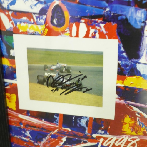 876 - An A2 size framed poster of 1998 F1 World Championship with mounted signed photograph of Champion Mi... 