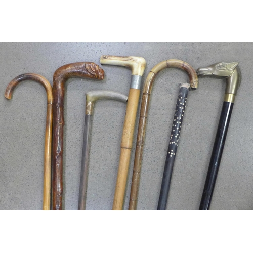 910 - A collection of seven walking sticks