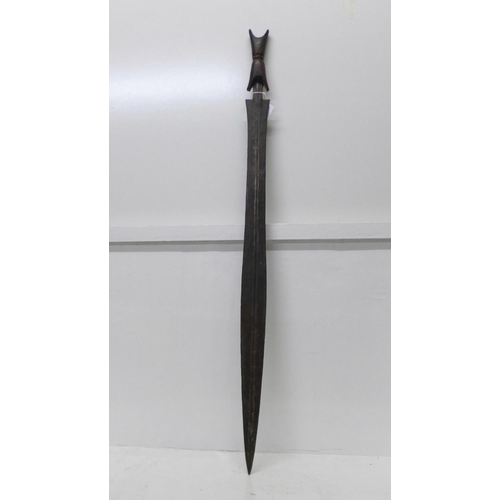 912 - An African tribal sword with wooden handle, etched blade, blade 75cm