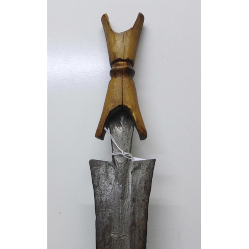 919 - An African tribal sword with wooden handle, etched blade, blade 69cm