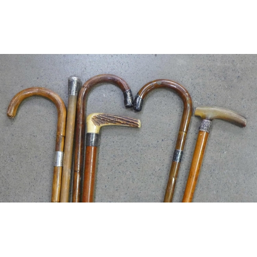 922 - Five walking sticks and one cane, all with silver embellishments