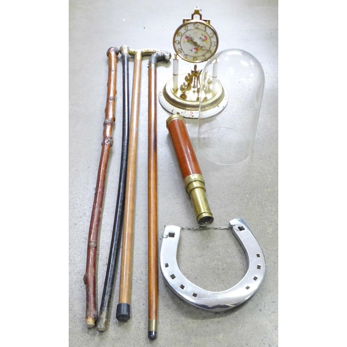 924 - Four walking sticks, a telescope a/f, a heavy chrome horseshoe and an anniversary clock, a/f