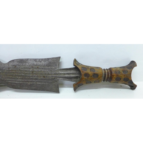 929 - An African tribal dagger and a pair of daggers with carved handles