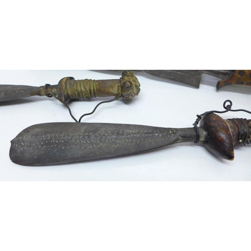 929 - An African tribal dagger and a pair of daggers with carved handles