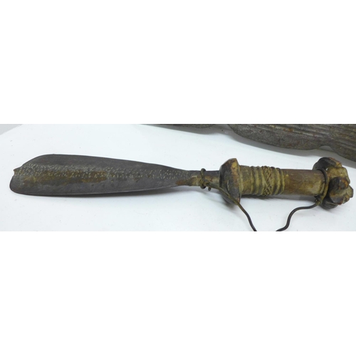 929 - An African tribal dagger and a pair of daggers with carved handles