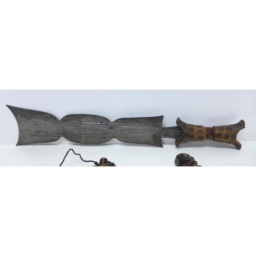 929 - An African tribal dagger and a pair of daggers with carved handles