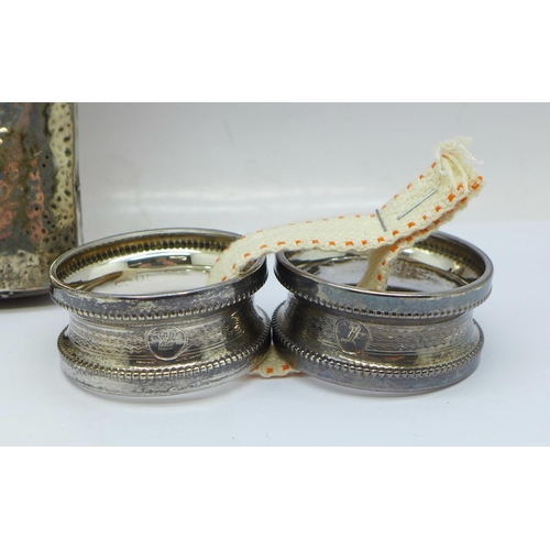 933 - A pair of silver napkin rings, a silver pocket watch travel case front, no back, and a Victorian sil... 