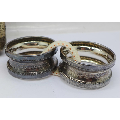 933 - A pair of silver napkin rings, a silver pocket watch travel case front, no back, and a Victorian sil... 