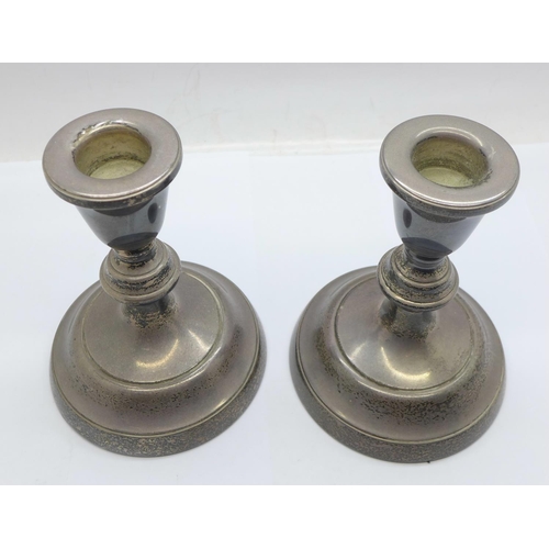 942 - A pair of silver candlesticks, 11cm