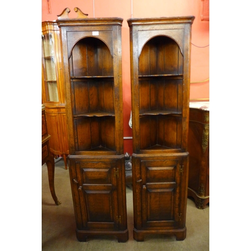 103 - A pair of Titchmarsh & Goodwin Ipswich oak freestanding corner cabinets, 167cms h