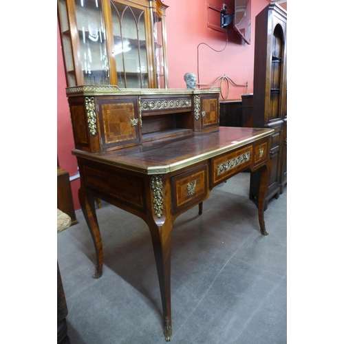 104 - A French Louis XV style inlaid walnut, gilt metal and marble topped bonheur de jour, 110cms h, 111cm... 