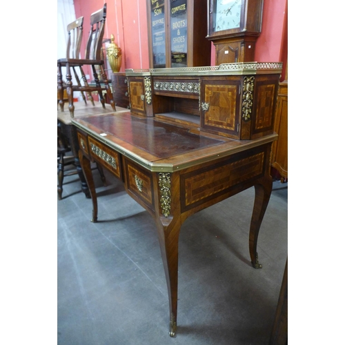 104 - A French Louis XV style inlaid walnut, gilt metal and marble topped bonheur de jour, 110cms h, 111cm... 