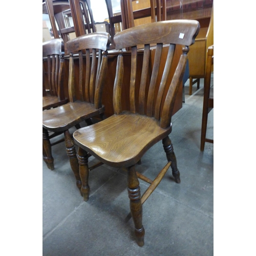 106 - A set of four Victorian elm and beech kitchen chairs