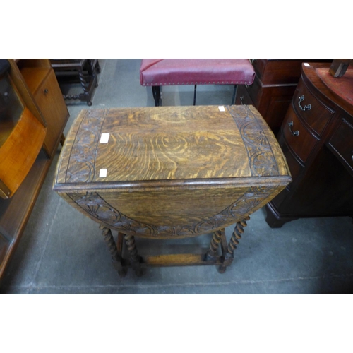 115 - A carved oak barleytwist gateleg table