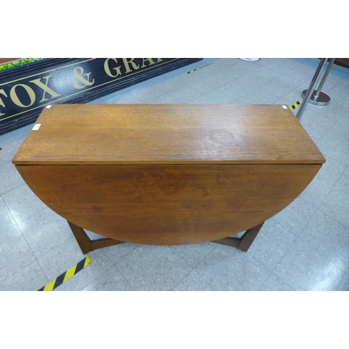 132 - A teak drop-leaf table