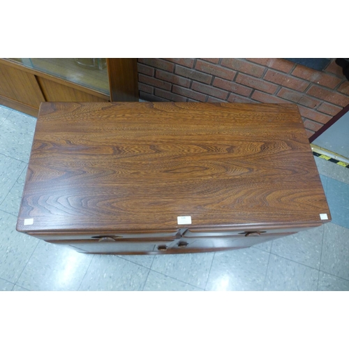 134 - An Ercol Golden Dawn elm Windsor sideboard