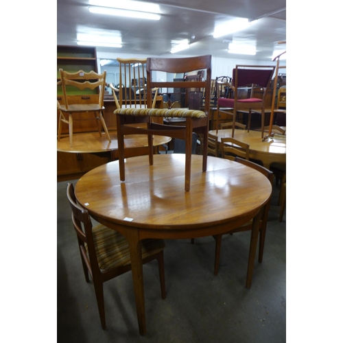 158 - A Nathan teak extending dining table and four chairs