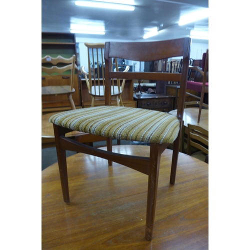 158 - A Nathan teak extending dining table and four chairs