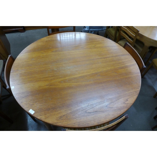 158 - A Nathan teak extending dining table and four chairs