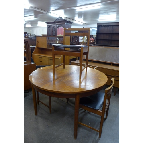 173 - A teak extending dining table and four chairs