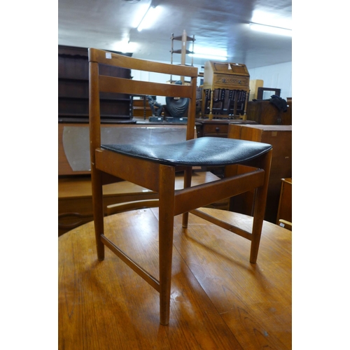 173 - A teak extending dining table and four chairs