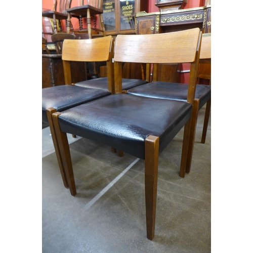 184 - A set of four teak and vinyl chairs