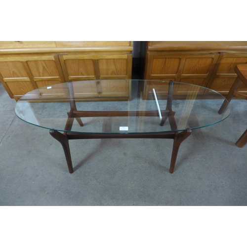 207 - A teak and glass topped oval coffee table