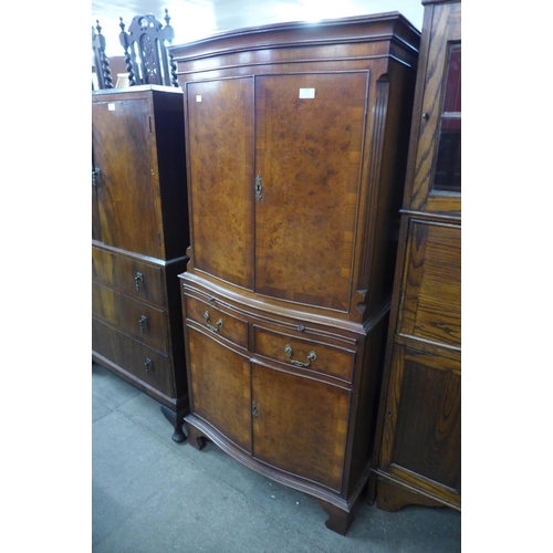 237 - A mahogany and burr walnut serpentine side cabinet