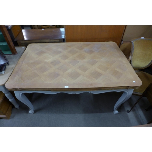 274 - A French carved hardwood and painted extending dining table