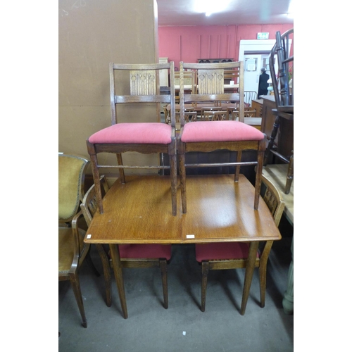 278 - An oak extending dining table and four chairs