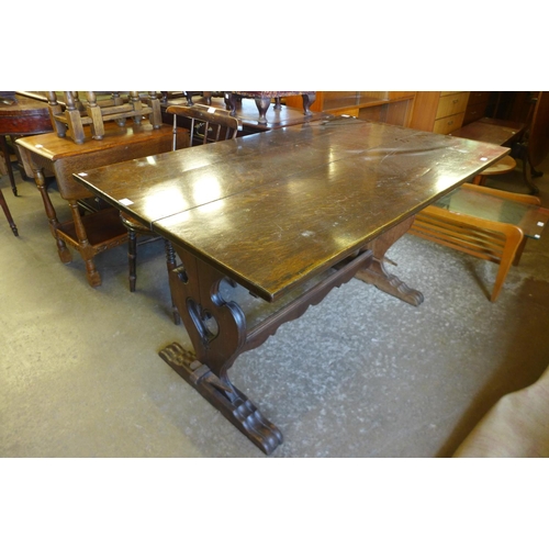 297 - A French carved oak refectory table, 74cms h, 133cms l,  78cms w