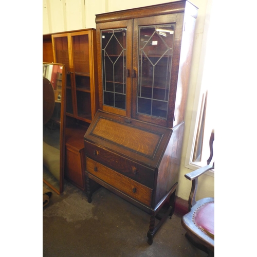 299 - An Art Deco oak barleytwist bureau bookcase