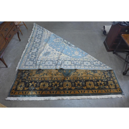 308 - A large blue and orange floral ground rug