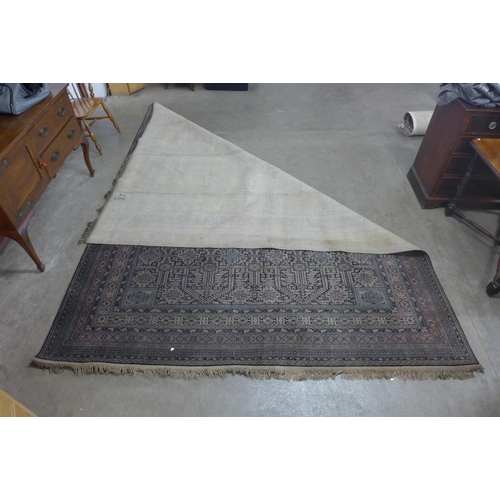 309 - A large blue, red and black ground rug