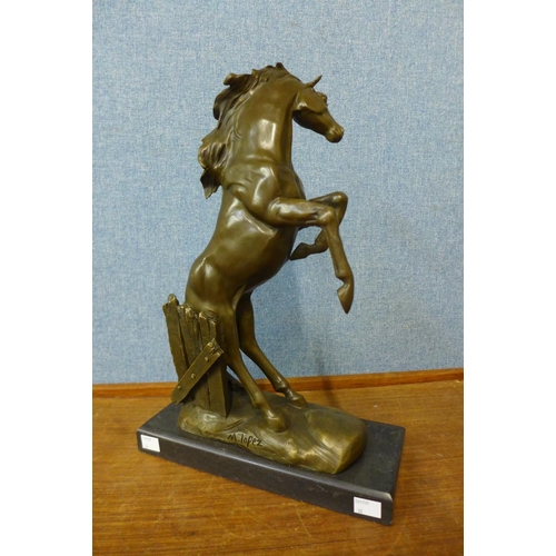 40 - A bronze figure of a rearing stallion, on black marble plinth, 41cm