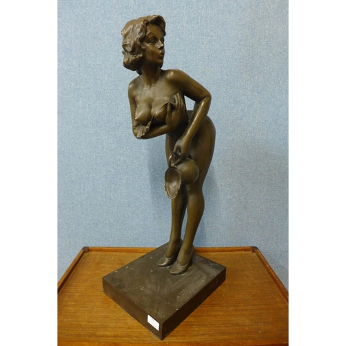 43 - A large bronze figure of a female nude holding a jug, 74cm h