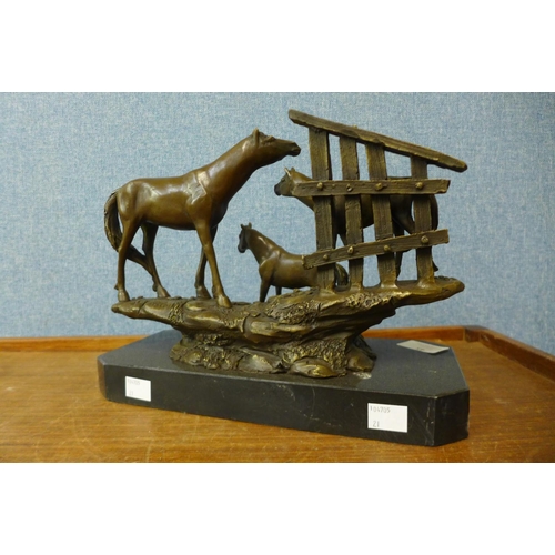 45 - A bronze figure group of a horse and foals, on black marble plinth, 21cm h