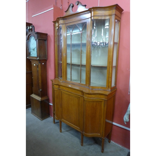 69 - A late Victorian Sheraton Revival inlaid satinwood display cabinet, 224cms h, 126cms w, 45cms d.