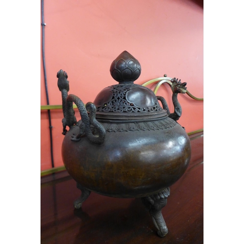 71 - An oriental bronze two handled koro and cover, 45cm h