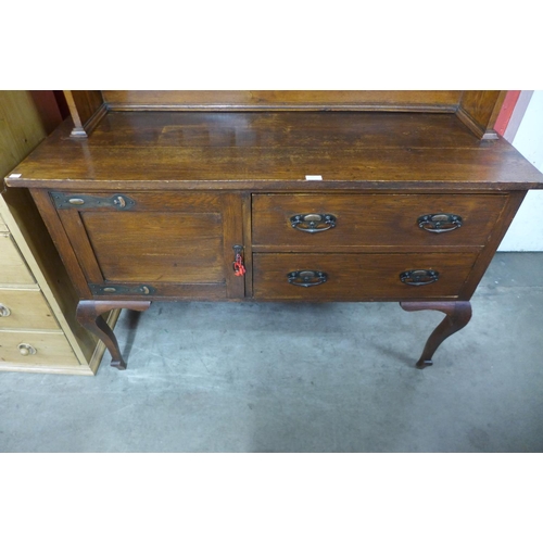 79 - An Arts and Crafts oak dresser, 188cms h, 137cms w, 49cms d.