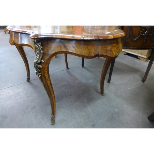 89 - A Victorian burr walnut and ormolu mounted serpentine centre table, 76cms h, 130cms L, 87cms w.