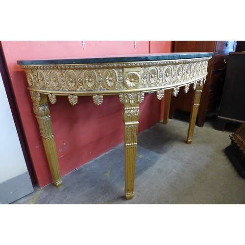 76 - A French style giltwood and marble topped demi-lune console table, 86cms h, 164cms w, 86cms h